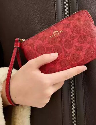 Coach Corner Zip Wristlet In Signature Canvas